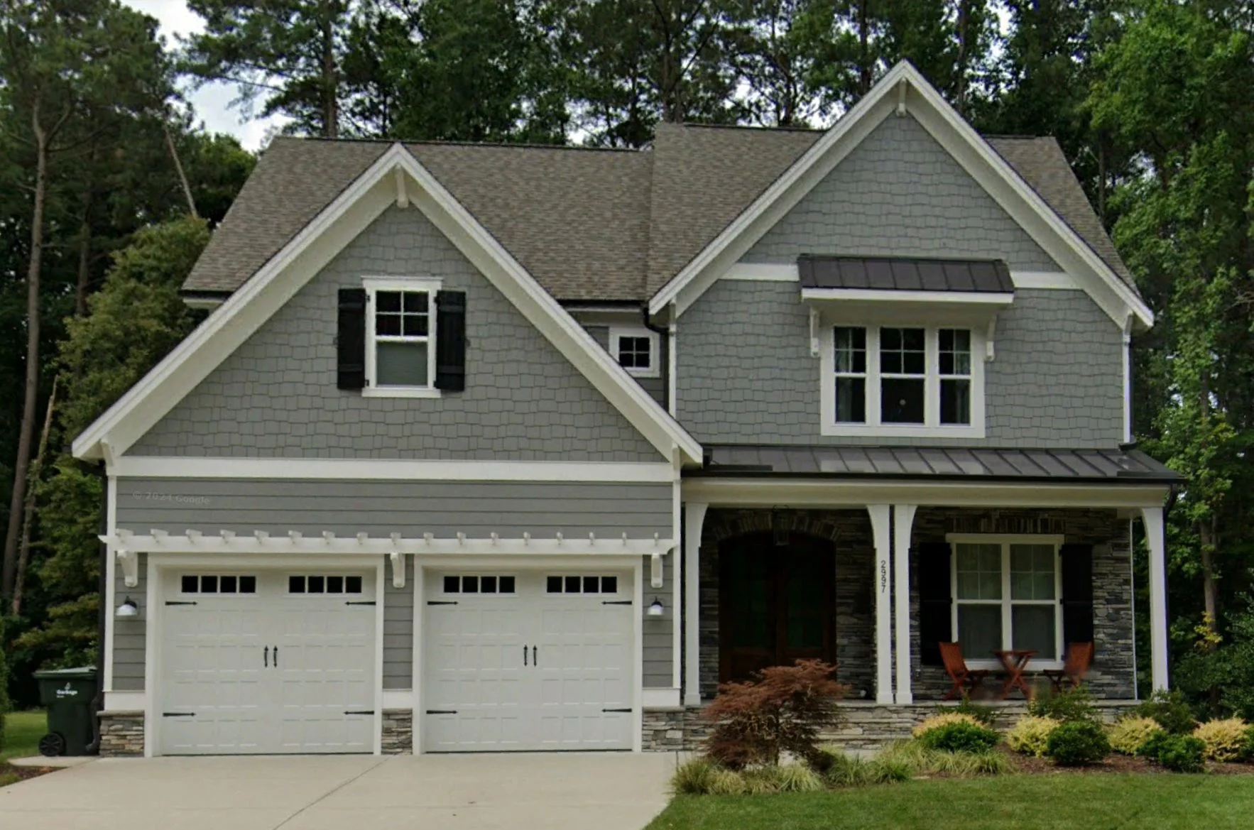 18-1636 HOUSE PLAN - Craftsman Home Plan - 4-Bed, 3-Bath, 2,750 SF 2 Front view of a Transitional Craftsman style house featuring gray shake siding, stone columns, board and batten trim, and a welcoming covered porch entry