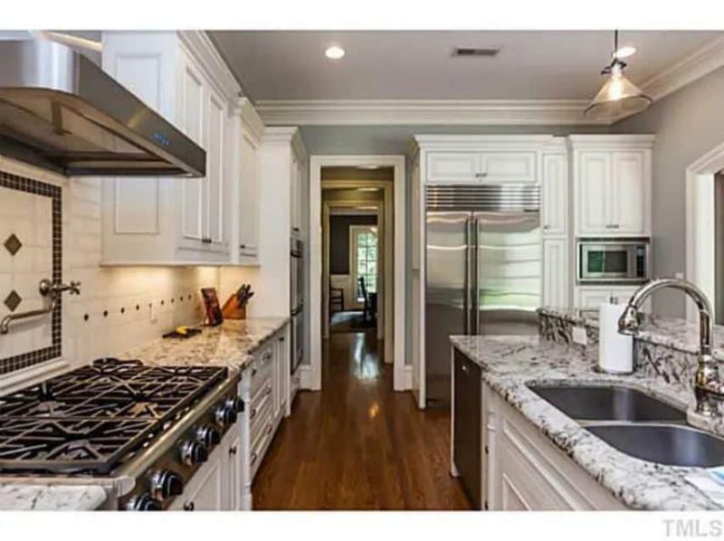 Traditional Craftsman house Plan with 4 Beds, 3 Garage Bays, and Vaulted Ceilings