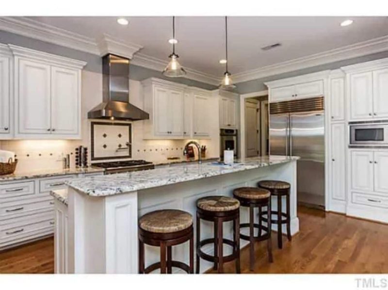 Traditional Craftsman house Plan with 4 Beds, 3 Garage Bays, and Vaulted Ceilings