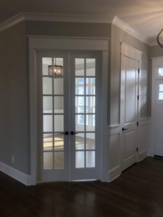 "Modern Craftsman house with spacious floor design and CAD blueprints on the table"