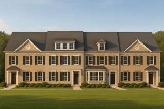 Front elevation of a Georgian Colonial townhome featuring brick and siding exterior, symmetrical windows, and classic black shutters.