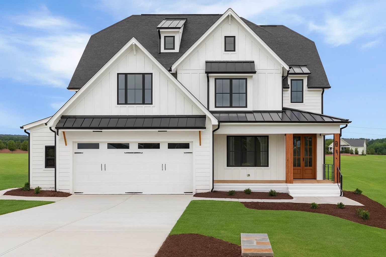 Front elevation of a Modern Farmhouse style home featuring white board and batten siding, black windows, standing seam metal roof accents, and an attached two-car garage