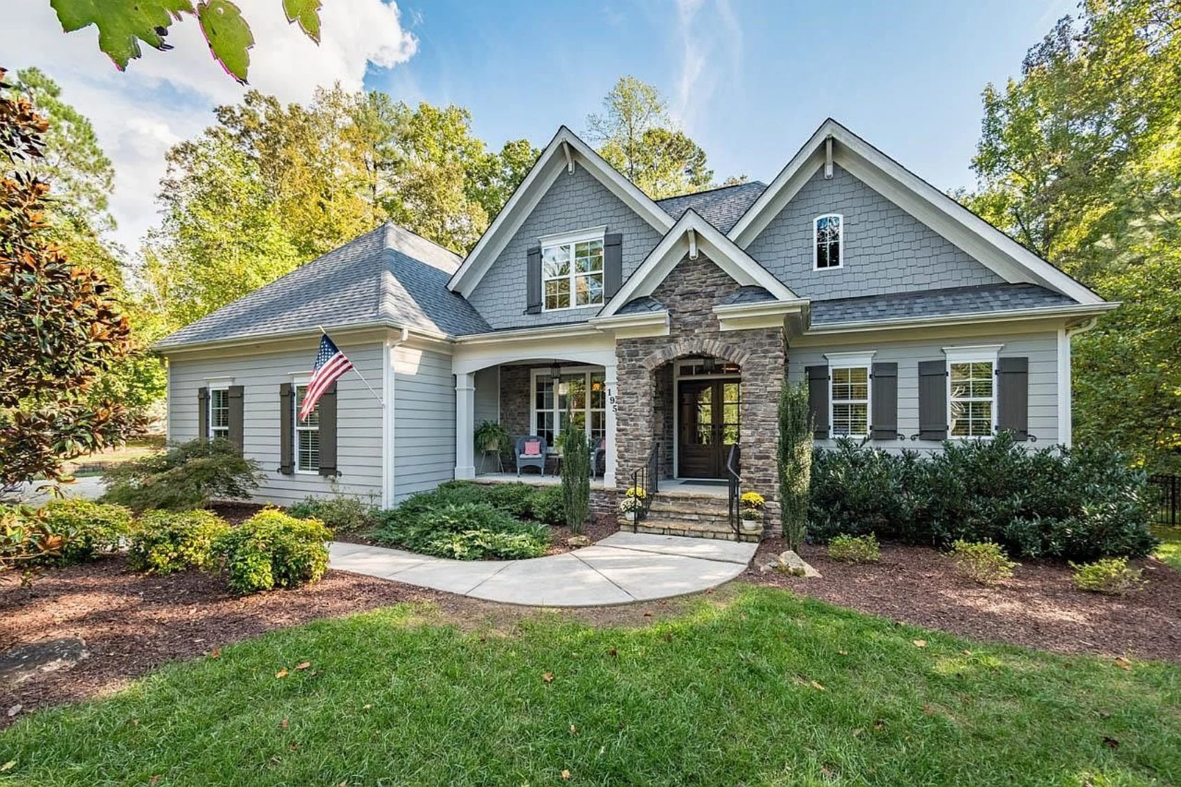 Craftsman Traditional house exterior with stone entry, gable roof, and front porch
