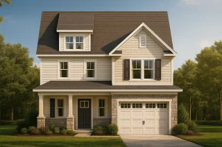 Front view of a Modern Farmhouse style home with stone base, horizontal and shake siding, gabled roofline, and a covered porch with single-car garage