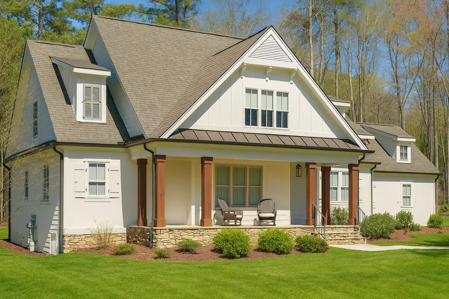Front elevation of a Modern Farmhouse style home featuring board and batten siding, metal porch roof, gabled dormers, and a welcoming covered front porch