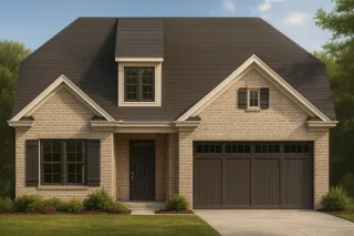 Front elevation of a Traditional Tudor Revival style home with brick exterior, steep gable rooflines, and symmetrical façade.