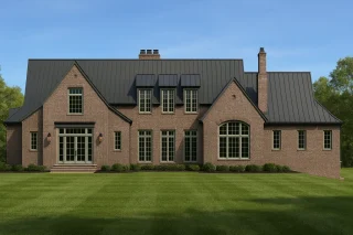 Front elevation of a Traditional Colonial brick home with symmetrical dormers, warm window lighting, and classic architectural detailing